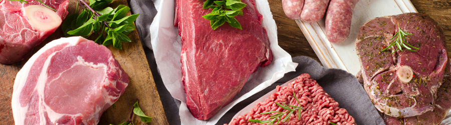 Sunset meat counter - a variety of raw meats on a cutting board