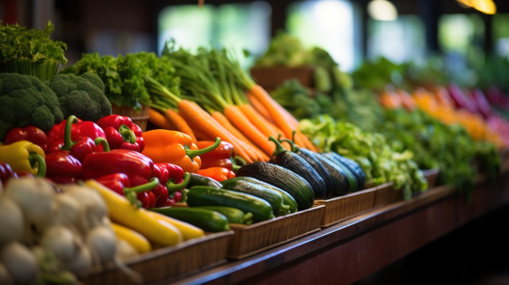 Fresh vegetables, including broccoli, bell peppers, and carrots, in the Sunset produce aisle