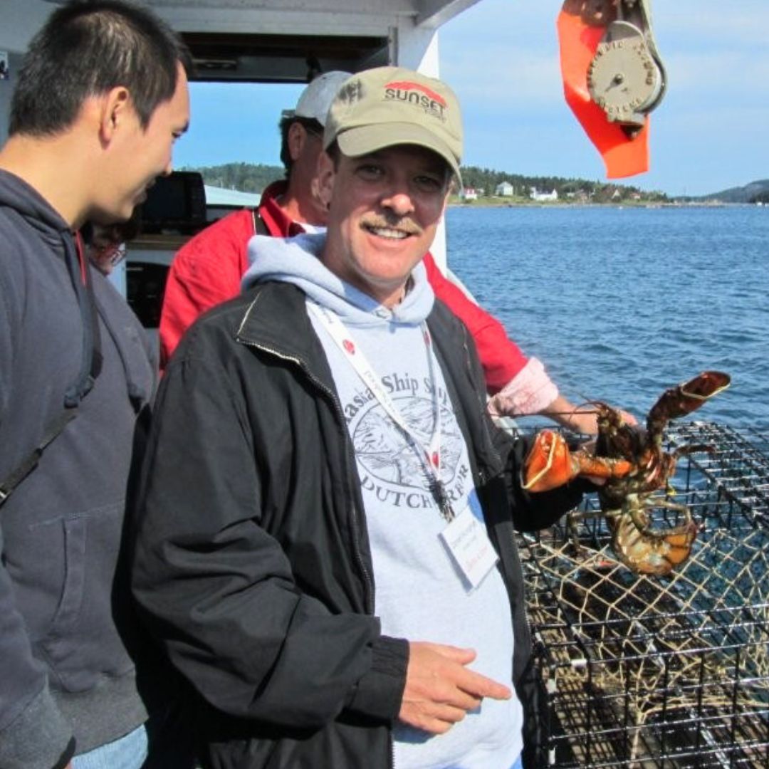 Sunset Seafood Director Dan Humphrey Catching a Maine Lobster
