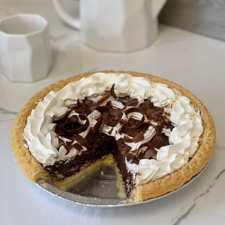 A slice of creamy pumpkin cheesecake and a rich french silk pie.